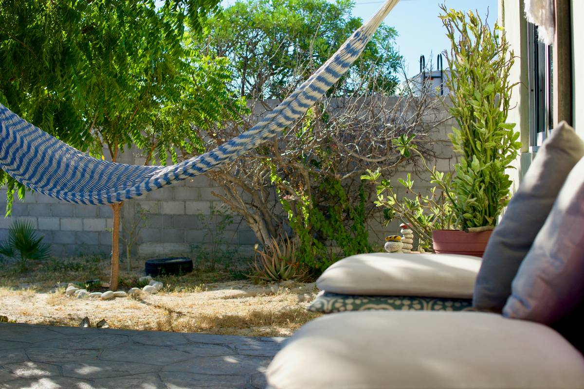 sun protection fireplace benefit of having a shaded stone fire pit under a pergola with lounge chairs