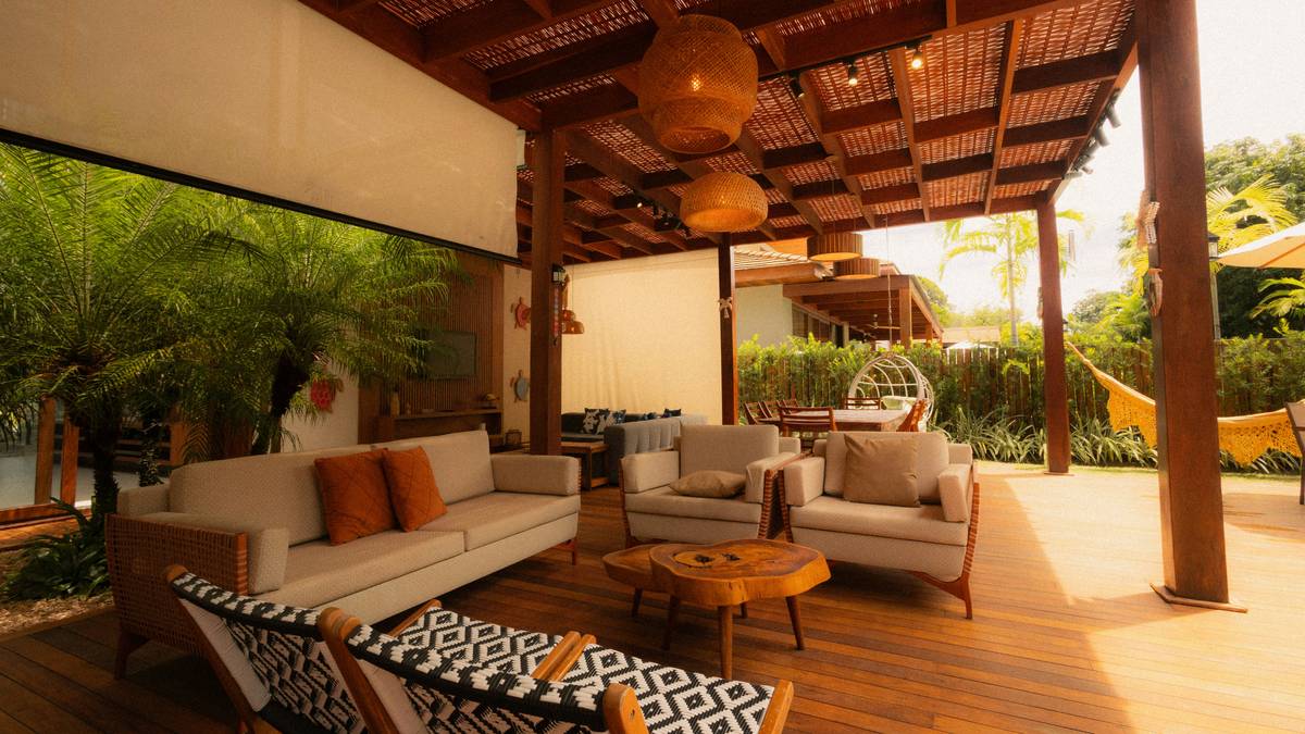 Modern backyard setup showcasing fireplace and patio trends with stone seating and integrated fire table