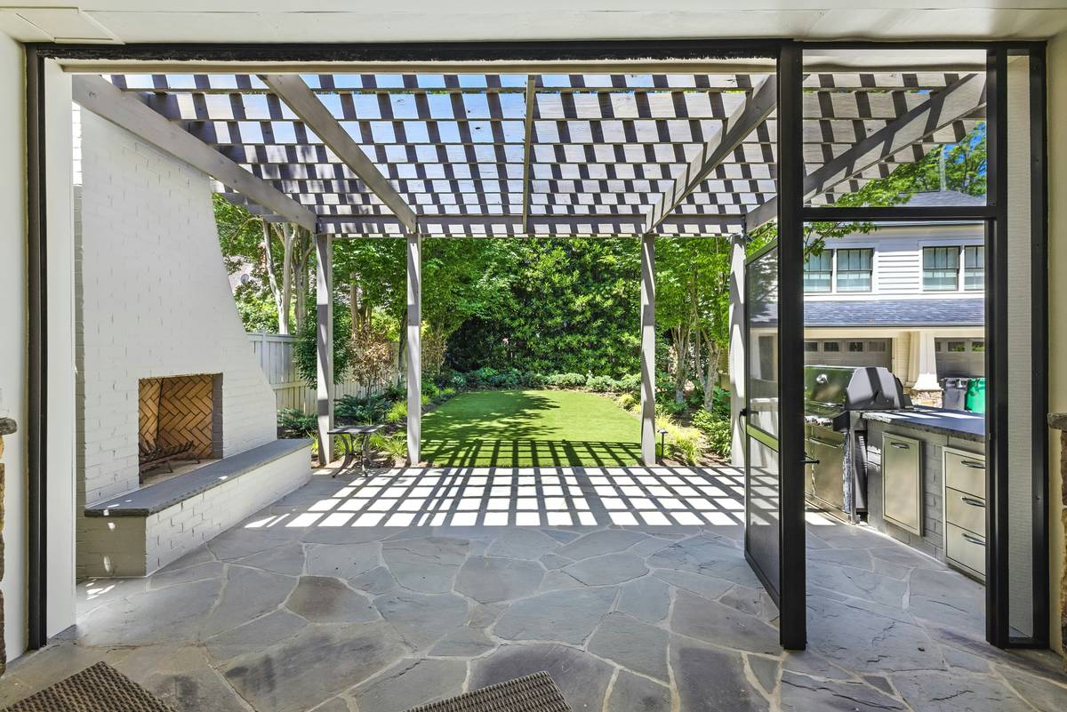 sun protection fireplace benefit of an outdoor stone fireplace shaded by a retractable canopy with comfortable seating nearby